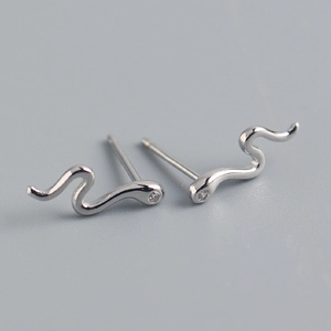 Macro view of S925 sterling silver snake stud earrings with crystal stone detail