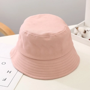 Close-up of pink cotton sun hat with reinforced brim stitching and warm macaron color