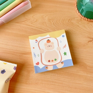 Close-up of cute cartoon bear sticky notes with persimmon theme on a wooden desk