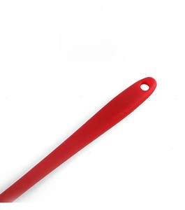 Detail of red silicone basting brush handle featuring a convenient hanging hole