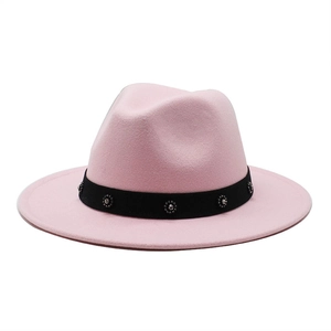 Detail of pink wool fedora hat featuring a black ribbon band with sparkling rhinestones