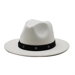 Detail of white felt fedora hat featuring black ribbon band with rhinestone embellishments