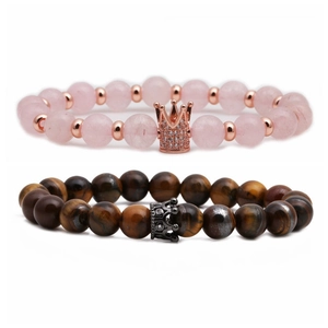 Tiger eye and pink crystal beaded crown bracelets for couples on white background