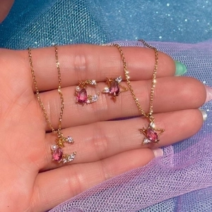 Star and moon necklace set with pink teardrop stones and pearls on golden chains