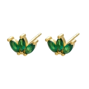 Macro detail of gold earrings featuring marquise green stones in a crown arrangement