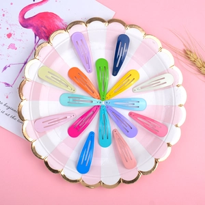 Detailed view of colorful 5cm metal drop hair clips arranged on a decorative plate