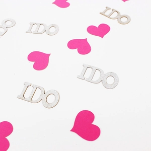 Close-up of pink heart and silver I DO glitter confetti for wedding party table decoration