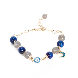 Moonstone and kyanite beaded bracelet with golden evil eye and crescent moon charms