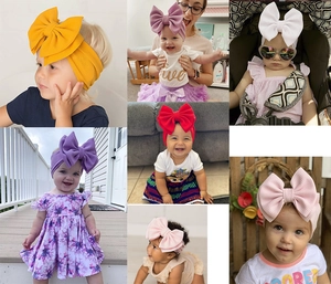 Detailed views of baby waffle knit headbands with oversized bows in various colors