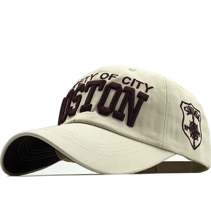 Detail of beige cotton baseball cap with 3D burgundy Boston embroidery and side shield patch