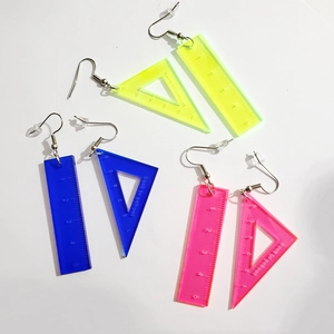 Three pairs of colorful acrylic ruler earrings in yellow blue and pink back to school style