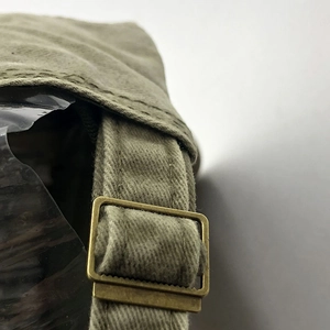 Detail of vintage washed cotton baseball cap with adjustable antique bronze metal buckle strap