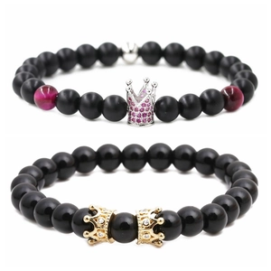 Matte and glossy black stone bead bracelets set with silver and gold crown charms