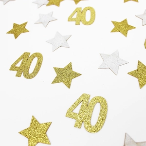 Close-up of sparkling gold and silver star-shaped confetti with number 40 for party decor
