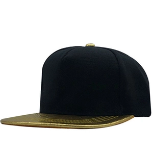 Side view of black cotton snapback hat featuring a shiny metallic gold flat brim