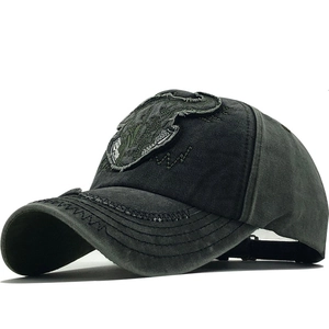 Vintage washed canvas baseball cap featuring embroidered bull patch and distressed olive green finish