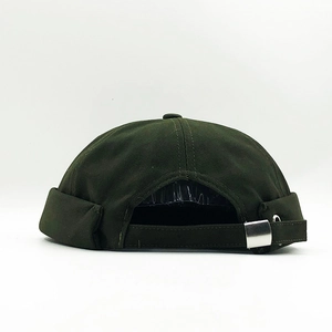 Detail of dark green cotton docker hat featuring adjustable metal buckle and six-panel crown
