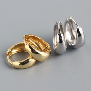 Macro view of elegant gold and silver hammered texture S925 sterling silver hoop earrings