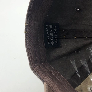 Detailed view of the 100% cotton washing label inside the shark baseball cap