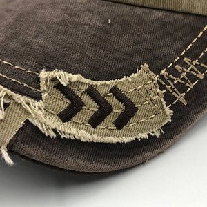 Macro detail of distressed canvas fabric and vintage embroidery on a baseball cap