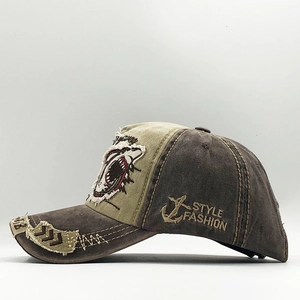 Detail of vintage washed baseball cap featuring shark mouth print and rugged contrast stitching