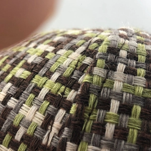 Close-up of winter plaid baseball cap showing thick tweed fabric and woven texture