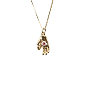 Golden Hamsa hand pendant necklace with evil eye detail on a polished box chain