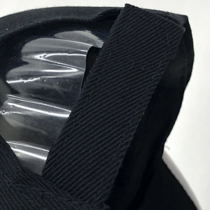 Detail view of the black baseball cap showing the adjustable velcro strap and PVC layer