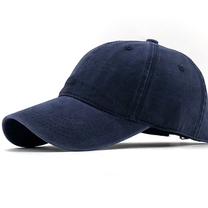 Detailed side view of navy blue washed cotton baseball cap with twill texture