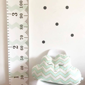 Detailed height chart for kids with green waves and wooden frame on polka dot wall