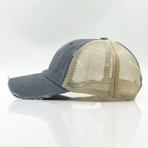 Detail view of distressed cotton brim and breathable mesh texture on the trucker hat