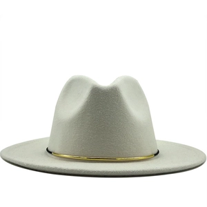 Close-up of white wool fedora hat featuring a stylish cylindrical gold buckle accent