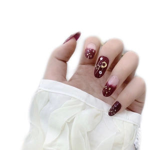 Star and moon burgundy gradient press-on nails with golden sequins and rhinestones
