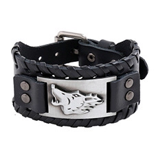 Close-up of a black leather Viking bracelet with a silver wolf head metal buckle