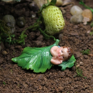 Miniature resin sleeping baby figurine in green leaf for fairy garden and succulent pots