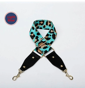 Adjustable light blue leopard print canvas strap with gold metal buckles and leather trim