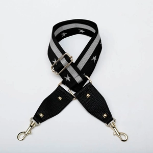 Detail of adjustable leopard strap with star pattern and golden metal buckles