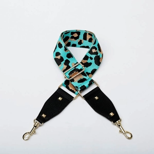 Adjustable leopard print bag strap with gold buckles and teal leopard pattern details