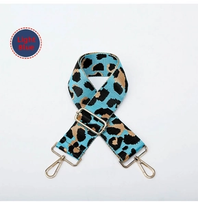 Macro shot of light blue leopard print strap with adjustable light gold metal buckle
