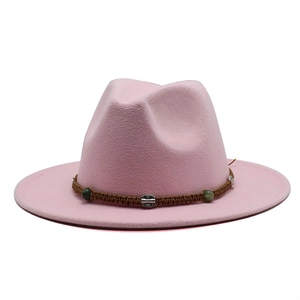 Close-up of pink wool fedora hat with braided brown band and decorative metal beads