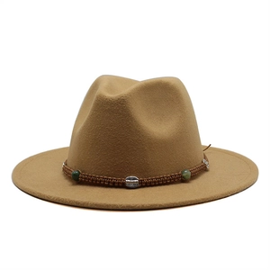 Detail of khaki wool fedora featuring braided band with green beads and silver buckle