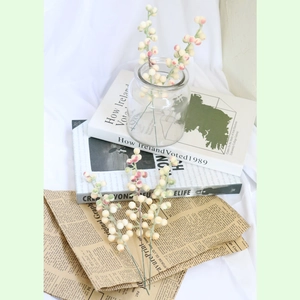 Artificial plush berry branches in a glass vase for Christmas home decoration and DIY
