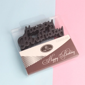 Detail of Happy Birthday letter candles in black with transparent retail packaging