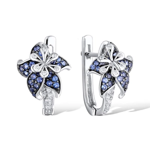Exquisite silver flower earrings with deep blue and white gemstones on white background