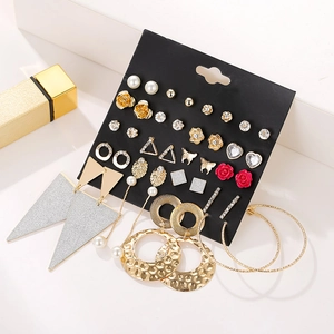 Detailed close-up of 30 pairs gold and silver alloy stud earrings with pearls and crystals
