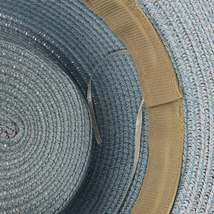 Detail of blue woven sun hat featuring interior sweatband and adjustable drawstring strap