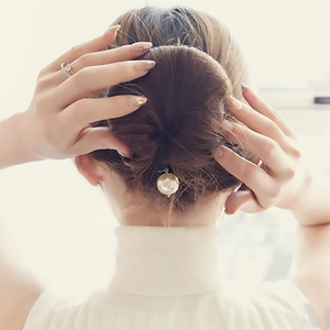 Elegant pearl hair bun maker accessory styled in a classic bun for women's hairstyle