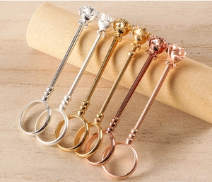 Detailed view of rose flower cigarette holders in gold, silver and rose gold metal