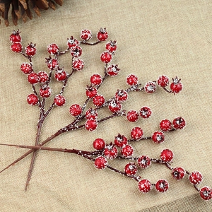 Artificial red berries with snow frost for Christmas tree decor on linen background