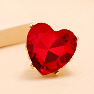 Macro shot of large heart-shaped red gemstone ring with elegant gold-tone multi-claw setting